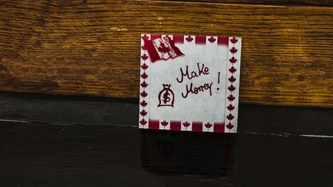 Text Make money on post it. Writing on sticky note with Canada flag. Buchar.. Stock Photos