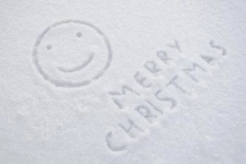 Text merry christmas and smiley on snow Stock Photos