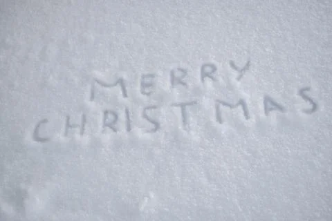 Text merry christmas on snow Stock Photos