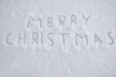 Text merry christmas on snow Stock Photos