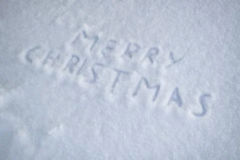 Text merry christmas on snow Stock Photos