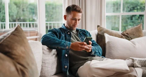 Text, message and man on sofa with phone, web search and online chat on social Stock Footage 341432906