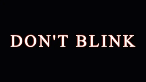 Text message DON'T BLINK appearing repeatedly in darkness with subtle light.. Stock Footage 345620614