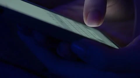 Text message with mobile phone. Side view of a smartphone in a woman's hand Stock-Footage 256809660