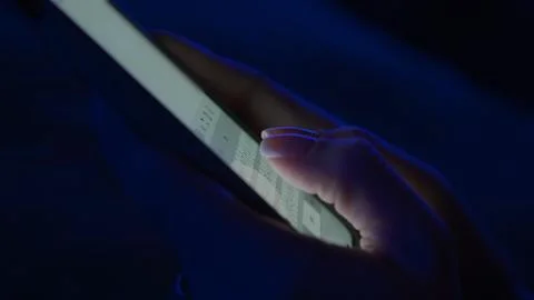 Text message with mobile phone. Side view of a smartphone in a woman's hand Stock Photos