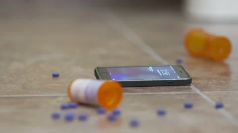 Text Message on Phone with Pills and Bottle on Floor Video stock 56597473