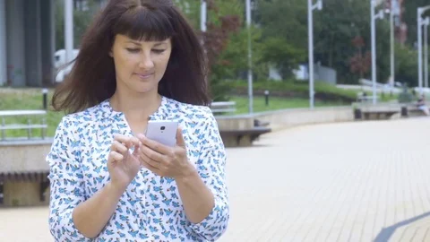 Text messaging. Woman using smartphone. Young attractive girl using smartphon Stock Footage 79055314