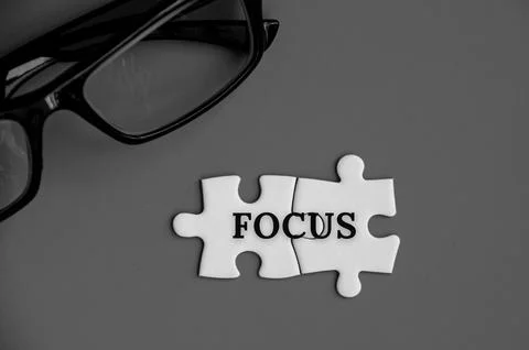 Text on missing jigsaw puzzle - Focus. With grey background. Stock Photos