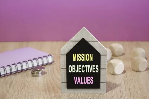 Text Mission objectives values on a black board. Beautiful purple background. Stock Photos