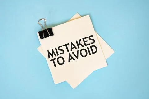 Text MISTAKES TO AVOID on sticky notes with copy space and paper clip isola.. 写真素材