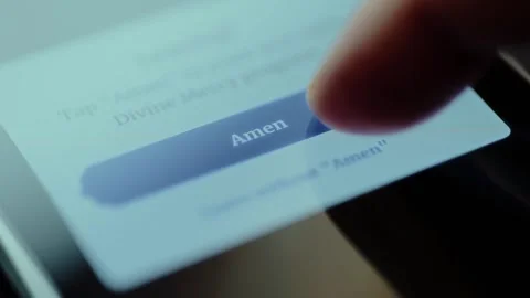 Text on the mobile phone screen with a button that says Amen Stock Footage 326943712