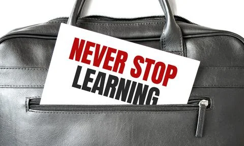 Text NEVER STOP LEARNING writing on white paper sheet in the black business b Stock Photos