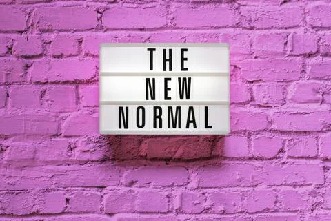 Text The new normal in lightbox on brick wall Stock Photos