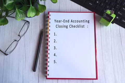 Text on notebook with hand tally counter clicker, glasses, pen and keyboard Stock Photos