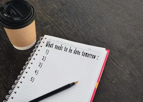 Text on notepad with background of cup of coffee and a pen Stock Photos