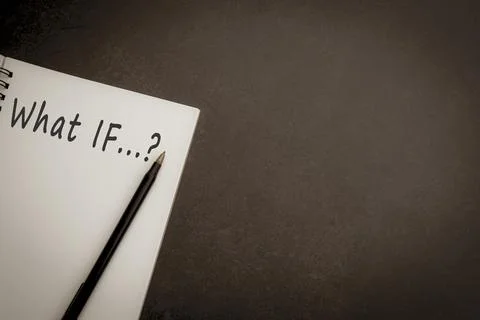 Text on notepad with dark background. What If question Stock Photos