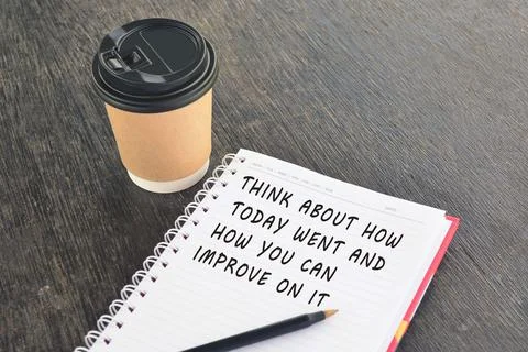 Text on notepad with disposable coffee cup wooden table Stock Photos