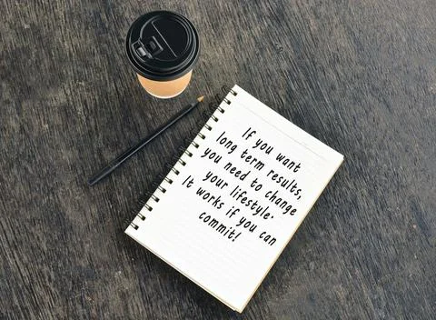 Text on notepad with disposable coffee cup wooden table Stock Photos