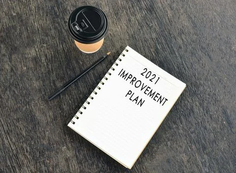 Text on notepad with disposable coffee cup wooden table Stock Photos
