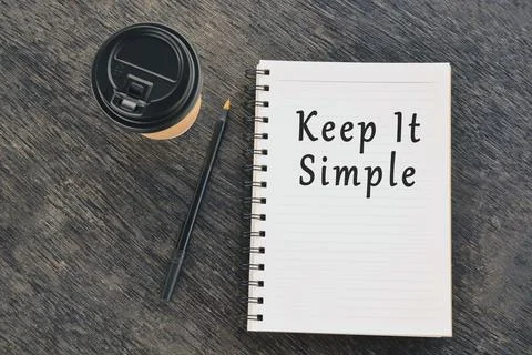 Text on notepad with disposable coffee cup and pen on wooden table Stock Photos