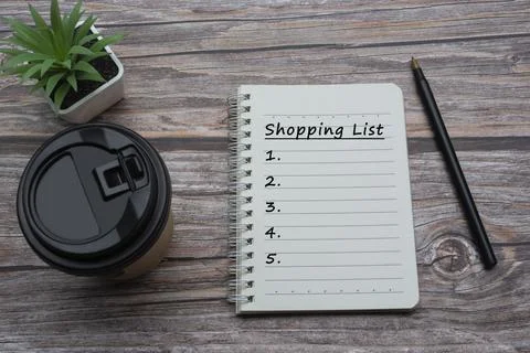 Text on notepad with disposable coffee cup on a wooden desk Stock Photos