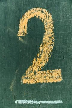 Text number two on chalkboard. Number two written hand chalk on board Stock Photos