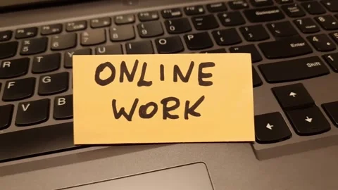 Text online work handwritten on paper note lying on computer keyboard Stock Footage 297085672