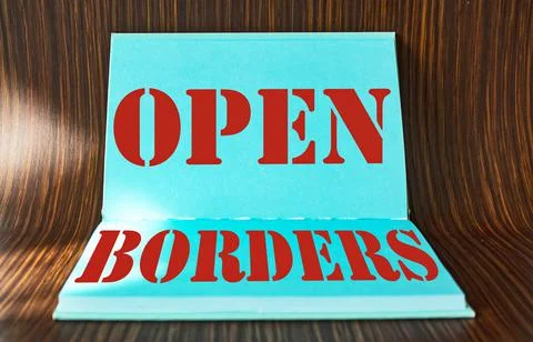 Text Open border in turquoise notebook on wooden background. Stock Photos