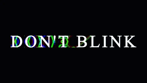 Text overlay 'Don't Blink' with glitch effect during dark scene for suspens.. Stock Footage 345620615