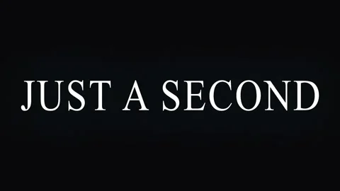 Text overlay with repeating phrase 'JUST A SECOND' in cinematic motion agai.. Video stock 344036151