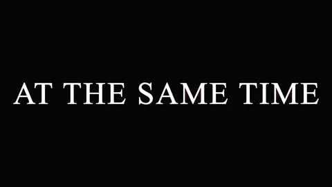 Text overlay AT THE SAME TIME repeated on black background with subtle cine.. Video stock 344036021