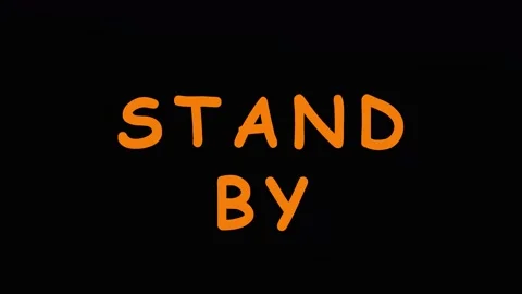 Text overlay of 'STAND BY' repeated six times against a dark background in .. Video stock 343416075