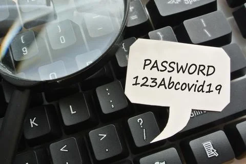 Text password 123Abcovid19 on  note on top of computer keyboard  Stock Photos