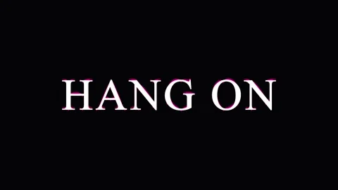 Text phrase 'hang on' repeats on black background with subtle lighting shif.. Stock Footage 345622223