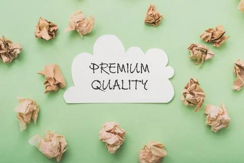 Text Premium Quality on a white speech bubble on a green background, crumpled Stock Photos