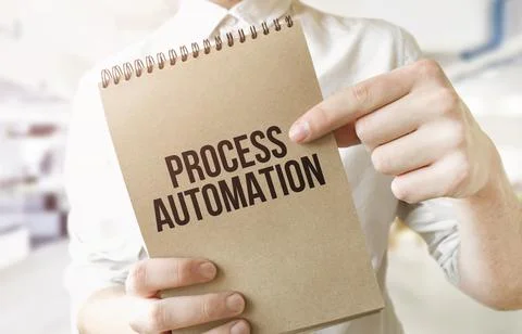 Text Process Automation on brown paper notepad in businessman hands in office Stock Photos
