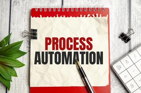 Text PROCESS AUTOMATION on Office desk on wooden background Foto stock