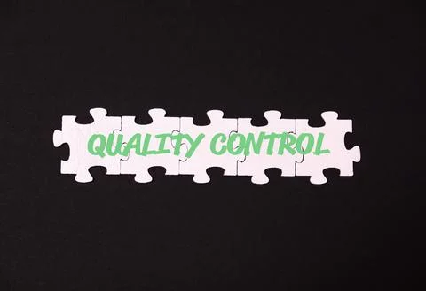 Text in puzzles on a black background Quality Control Foto stock