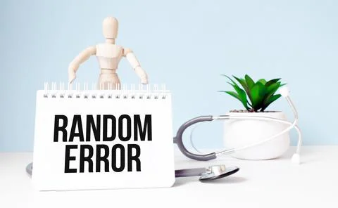 The text RANDOM ERROR is written on notepad and wood man toy near a stethosco 写真素材