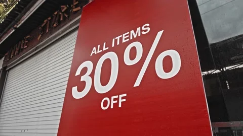 Text on a red banner standing on the street with the inscription 30% off Stock Footage 140680845