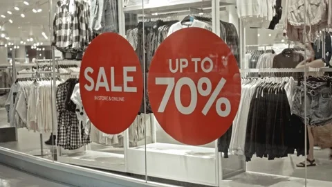 Text on the red sticker on the glass of window in the store with the inscript Stock Footage 141066442
