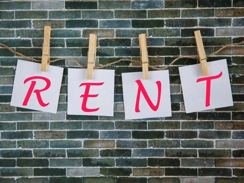 Text rent Note written on white square paper sheets that hangs with clothespi Stock Photos