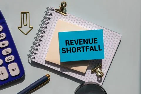 The text Revenue is flushed down the drain. Stock Photos