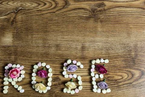 The text rose formed with marshmallows filled with button roses. Stock Photos