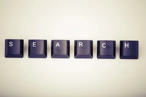 Text search formed with computer keyboard keys on white backgrou Stock Photos