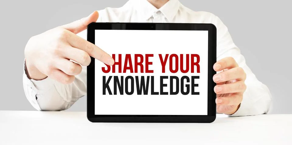 Text SHARE YOUR KNOWLEDGE on tablet display in businessman hands on the white Stock Photos