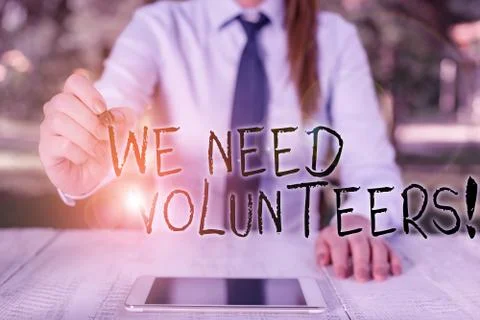 Text sign showing We Need Volunteers. Conceptual photo someone who does work Stock Photos