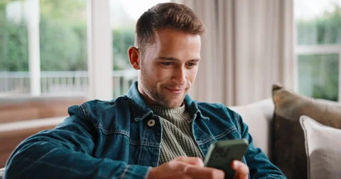 Text, smile and man on couch with phone, web search and online chat on social Stock Footage 341426828