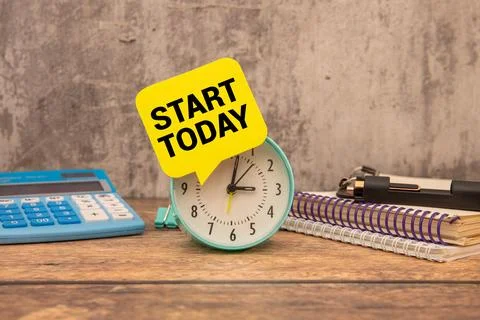 Text start today on paper card and calculator on wooden background Stock Photos