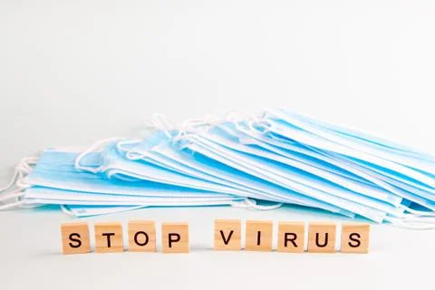 Text "stop virus" with copy space on the background of protective face masks. Stock Photos